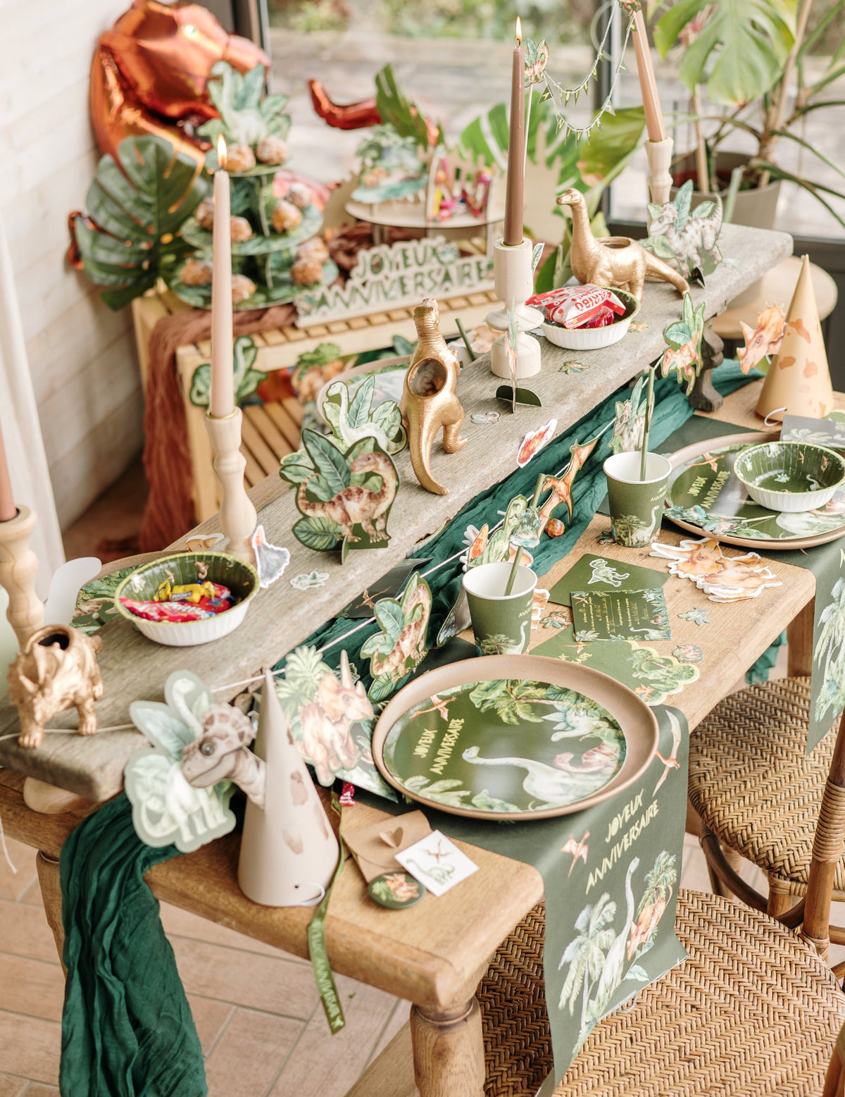 Vue d'ensemble de la table de fête avec les assiettes dinosaures joyeux anniversaire