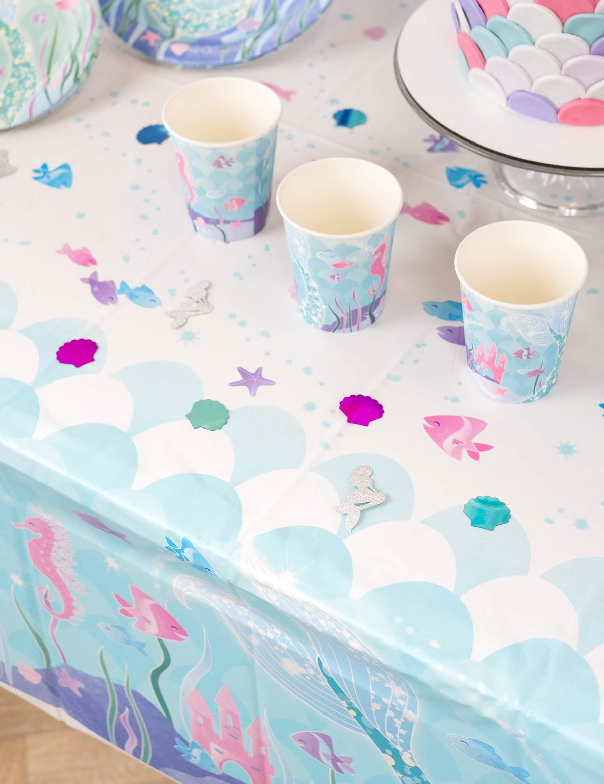Encenação sobre uma mesa decorada com confettis de mesa sereias