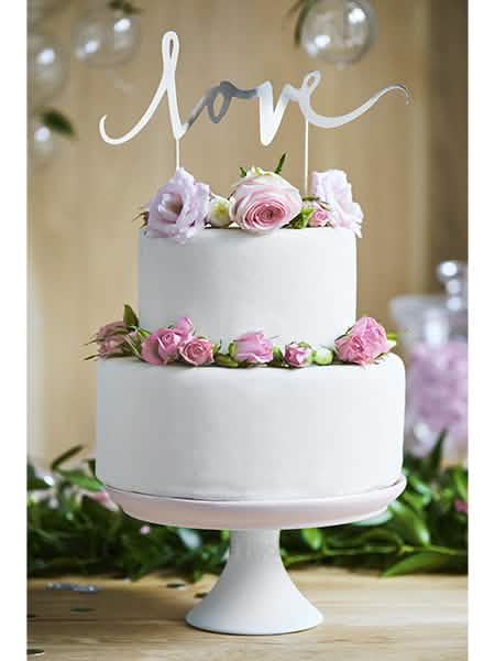 Colocação sobre um bolo do pic decorativo para bolo love