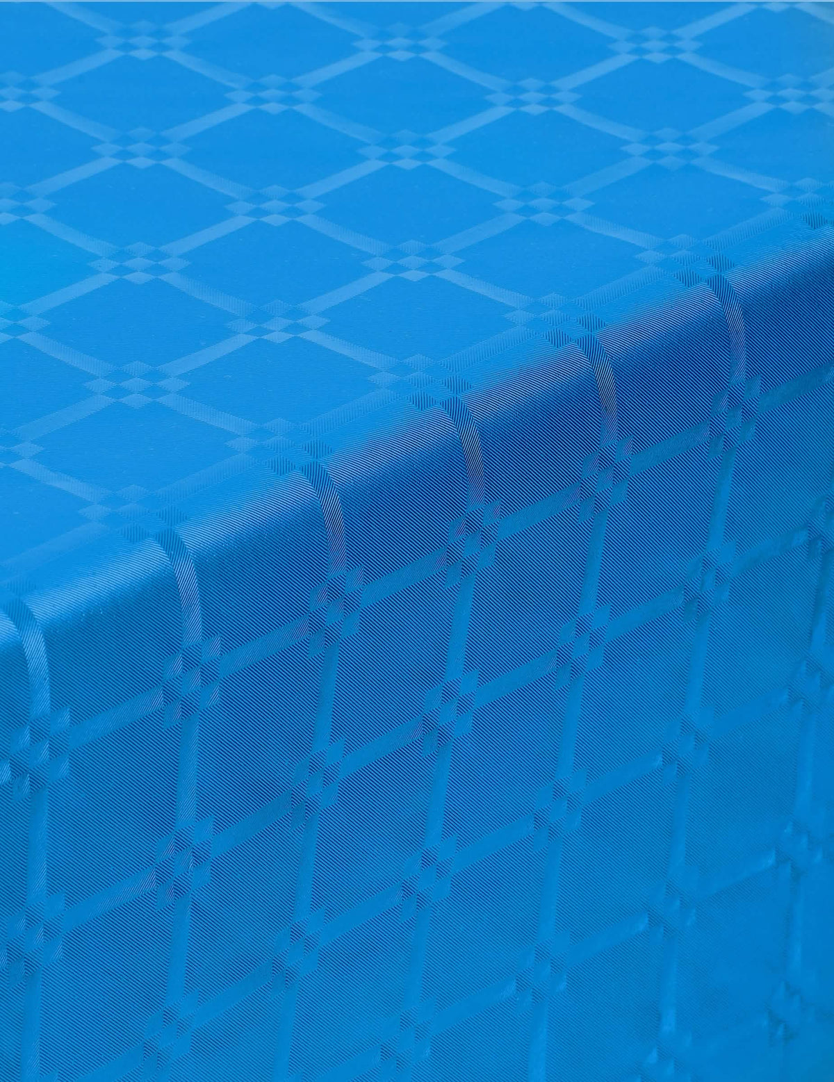 Plano de perto do relevo da toalha de mesa em rolo de papel damasco azul com motivos de frisos gregos