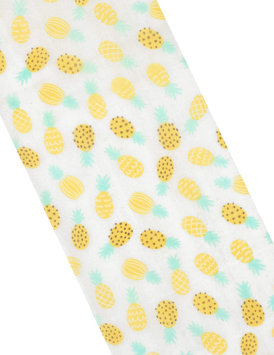 Gros plan sur les motifs du chemin de table intissé ananas blanc et jaune