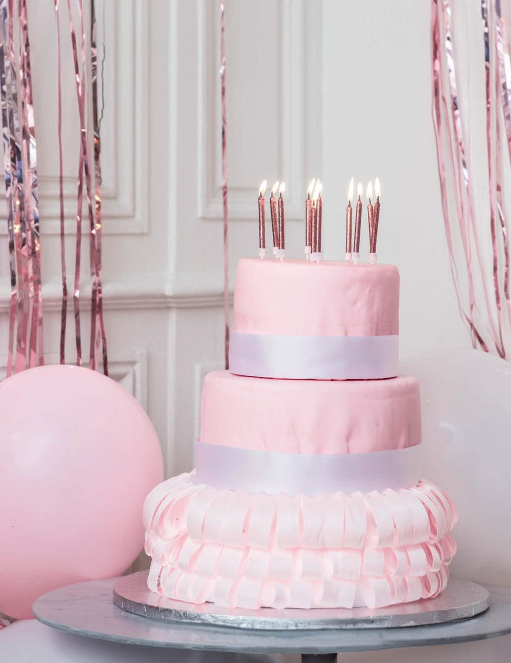 Cena em cima de um bolo de 10 velas com suportes de aniversário em ouro rosa com purpurinas