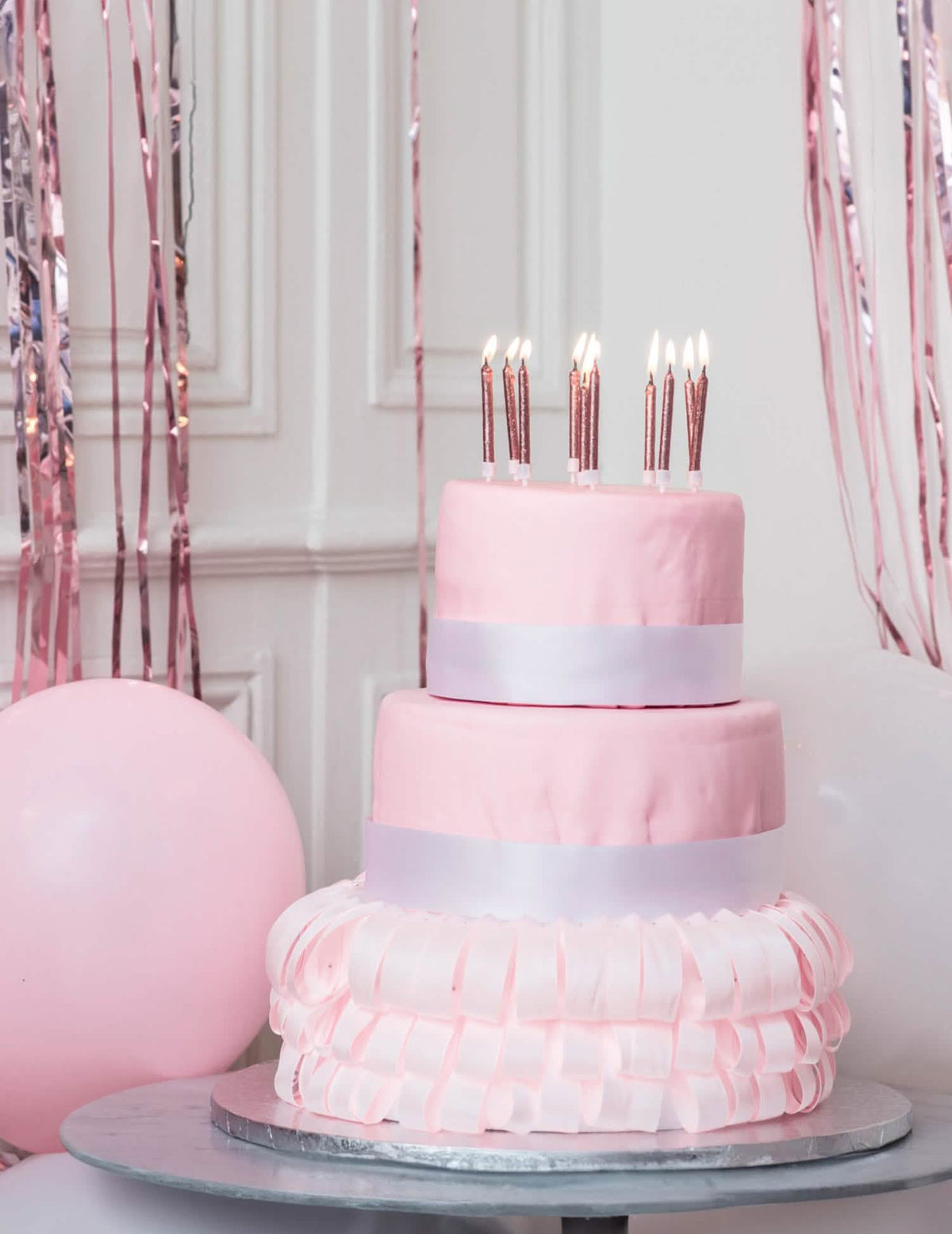 Cena em cima de um bolo de 10 velas com suportes de aniversário em ouro rosa com purpurinas