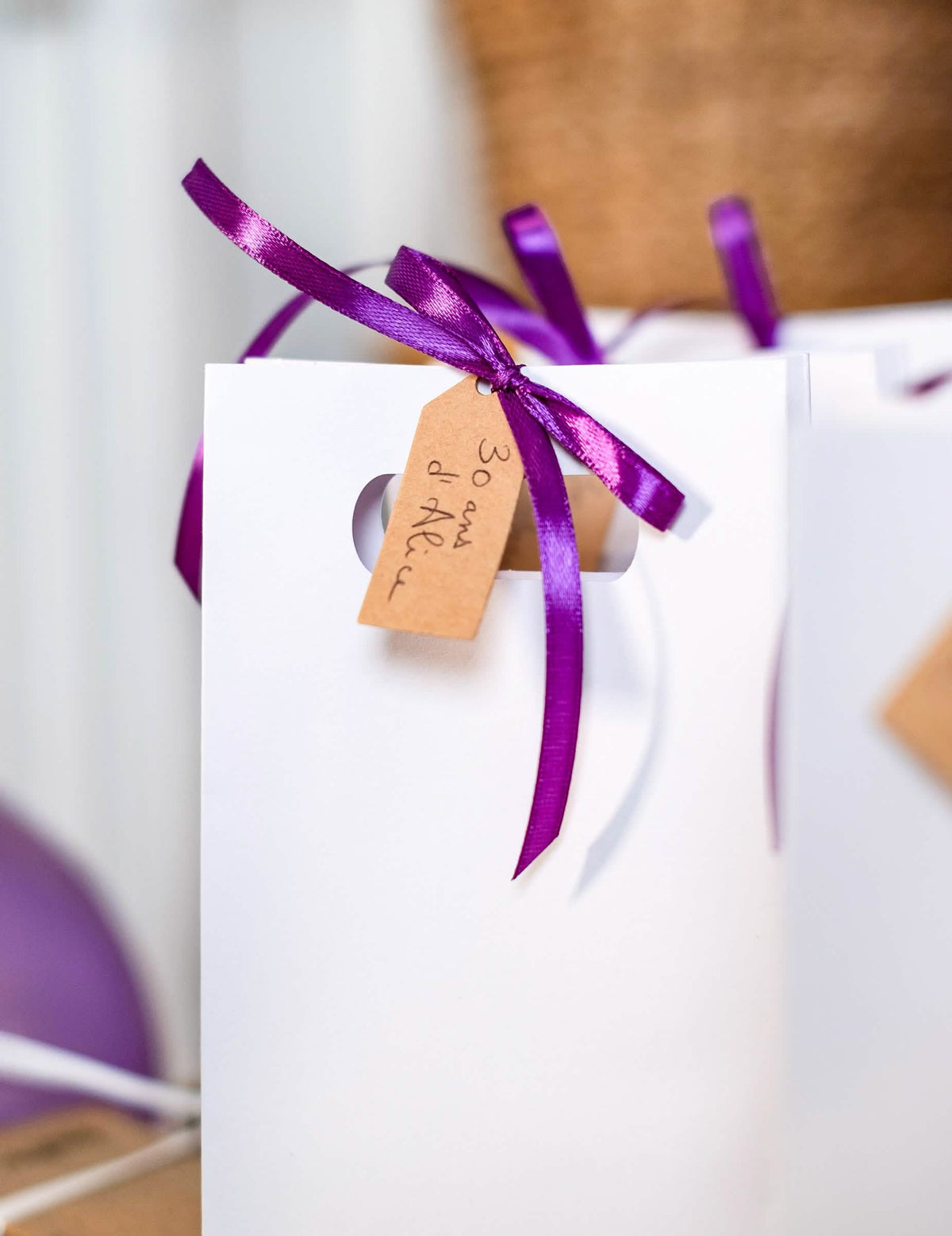 Detalhe da fita roxo e da etiqueta kraft do saco de papel casamento