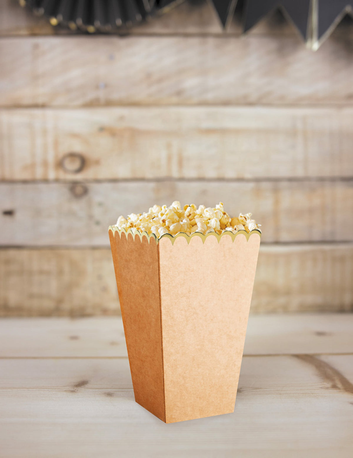 Zoom sur une boîte remplie des boîtes à pop corn kraft et or