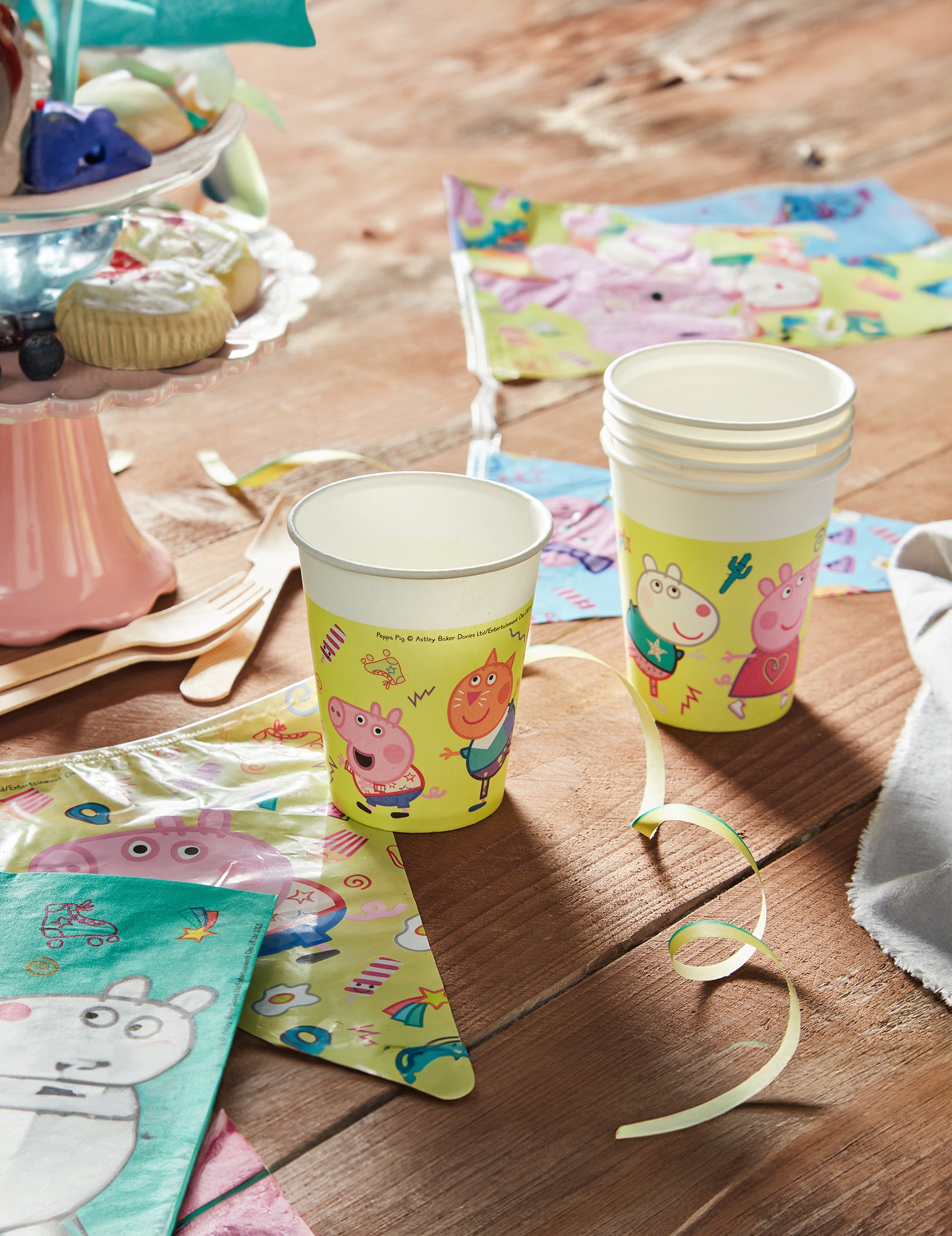 Mise en situation sur une table d'anniversaire des gobelets en carton Peppa Pig