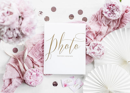 Mise en scène avec décor floral de l'album photo mariage blanc et doré