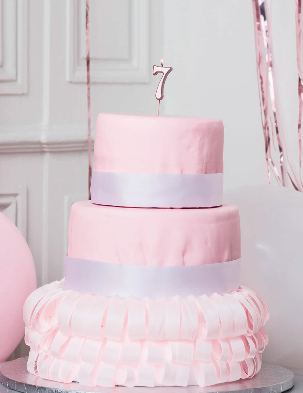 Topo de bolo com vela de aniversário número 7 em ouro rosa metalizado