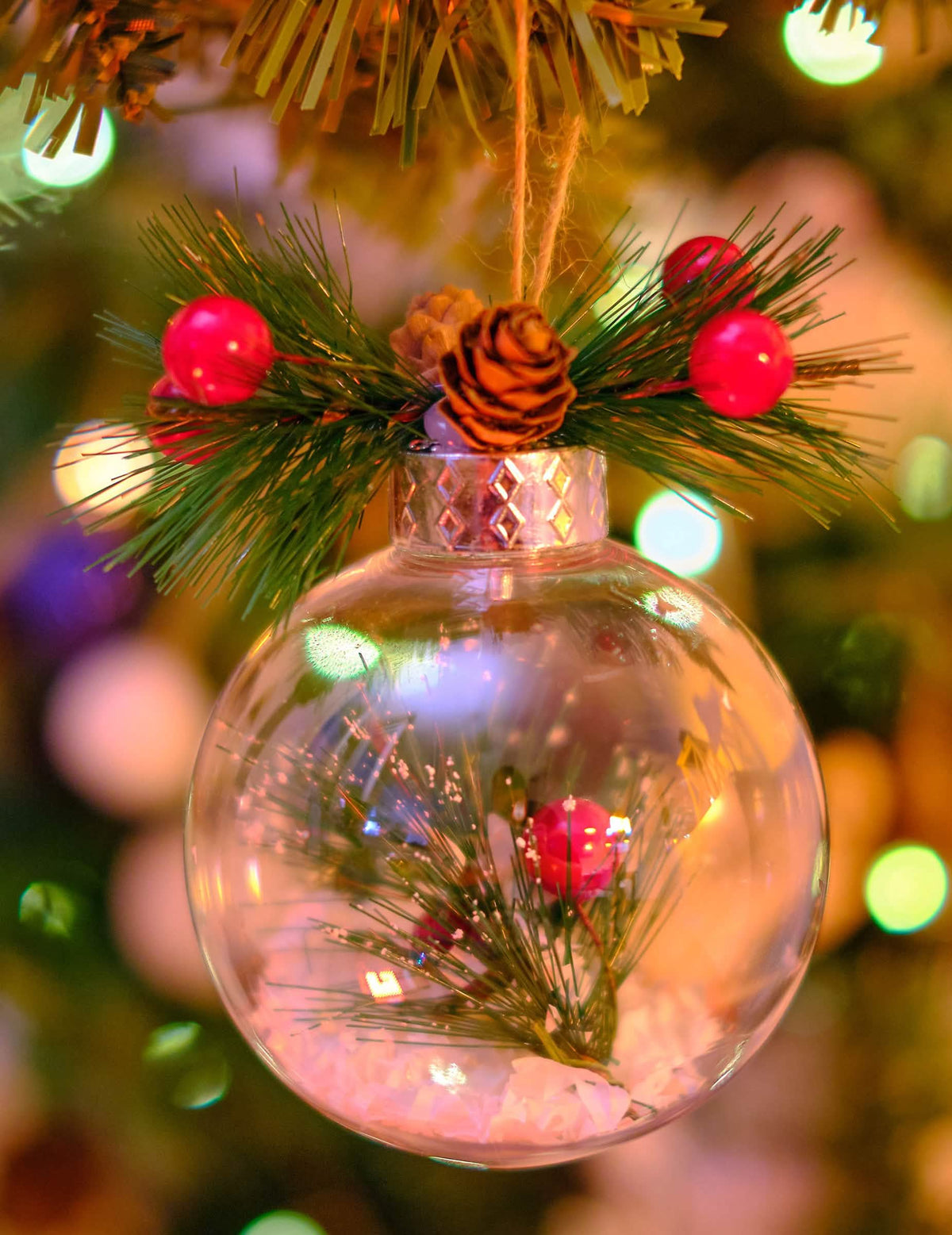 Grande plano da pinha e dos bagos da bola de natal natural com neve e pinheiro