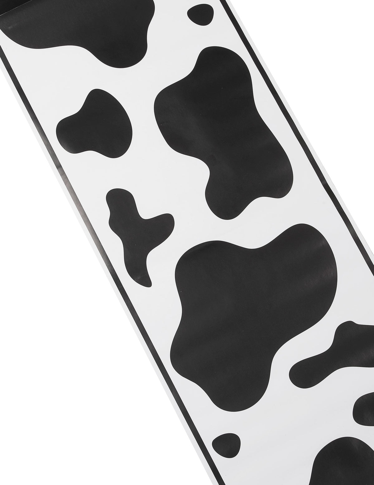 Gros plan sur les motifs à taches du chemin de table vache