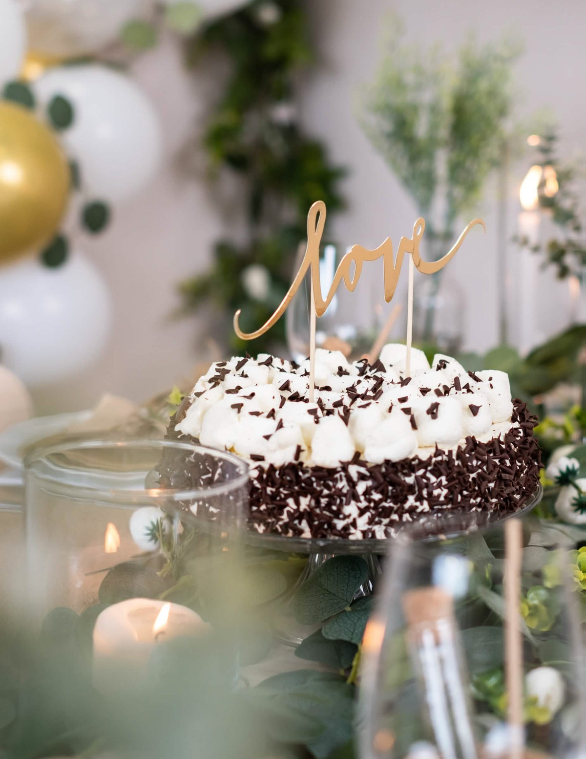Ambiente de mesa de festa com a decoração para bolo love para casamento dourado