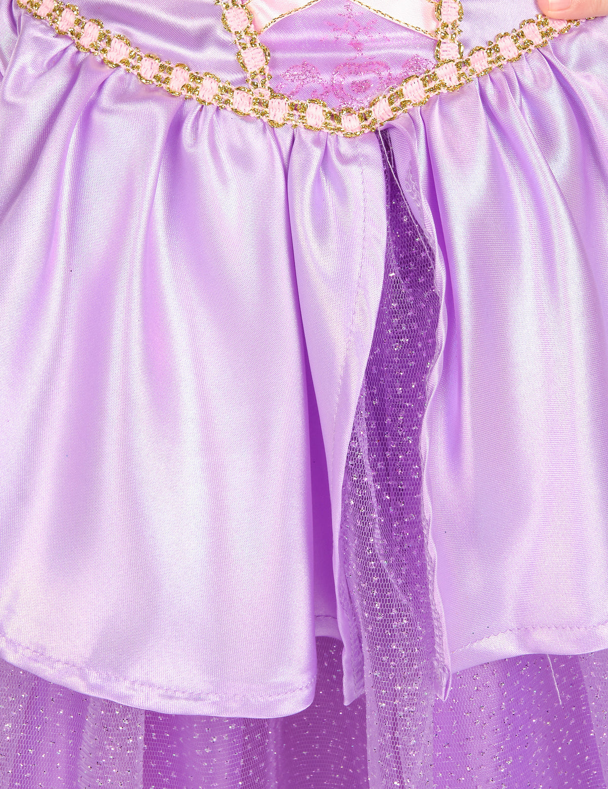 Détail de la jupe satinée et du jupon pailleté du déguisement deluxe Raiponce™ pour fille