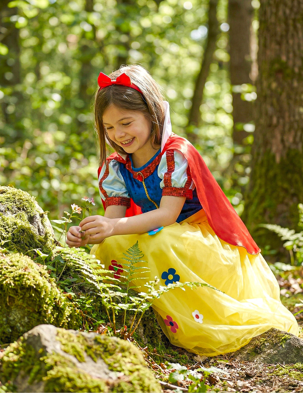 Pose dans les bois avec une fleur du déguisement princesse à fleur pour fille