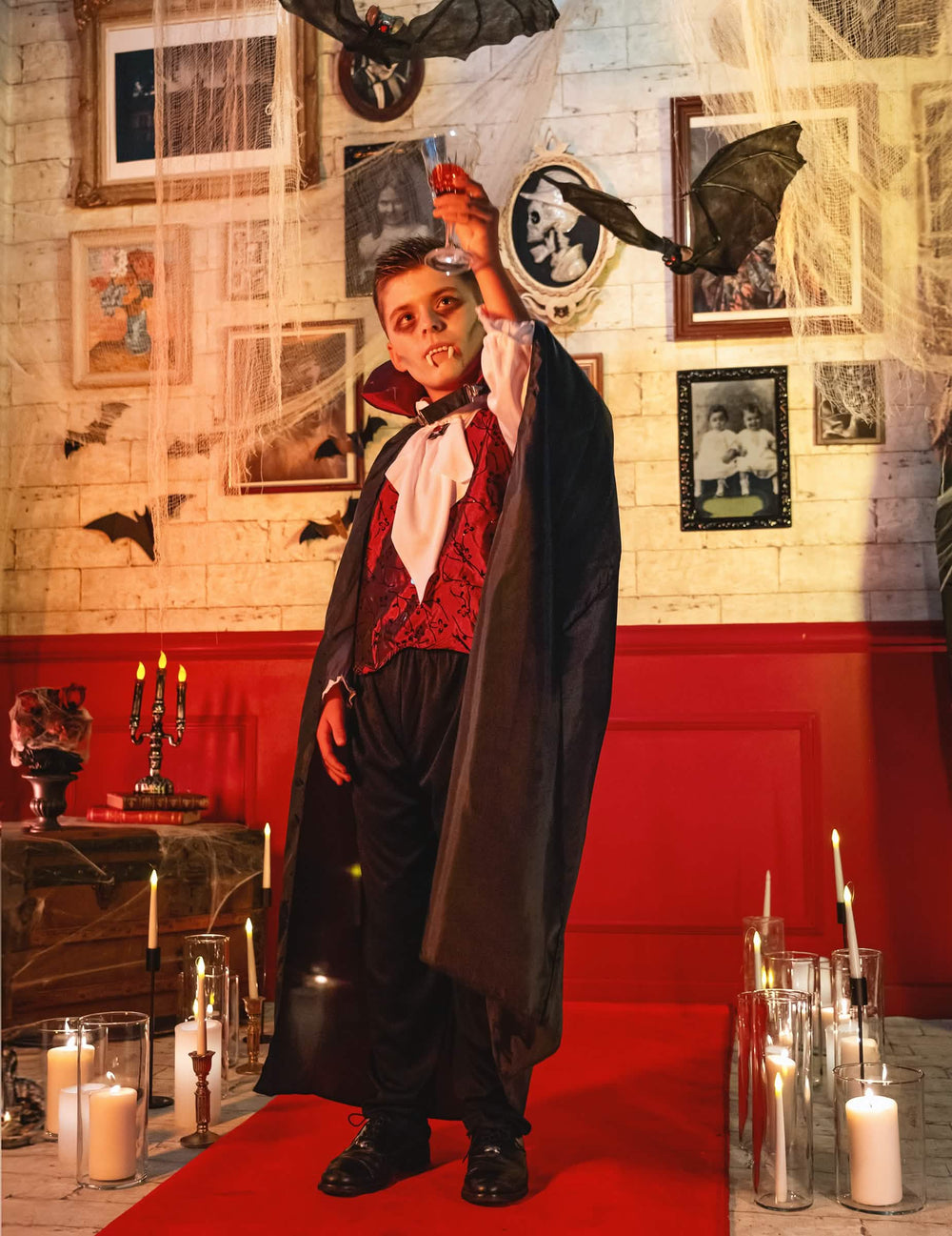 Encenação do disfarce de vampiro elegante para menino num cenário de halloween