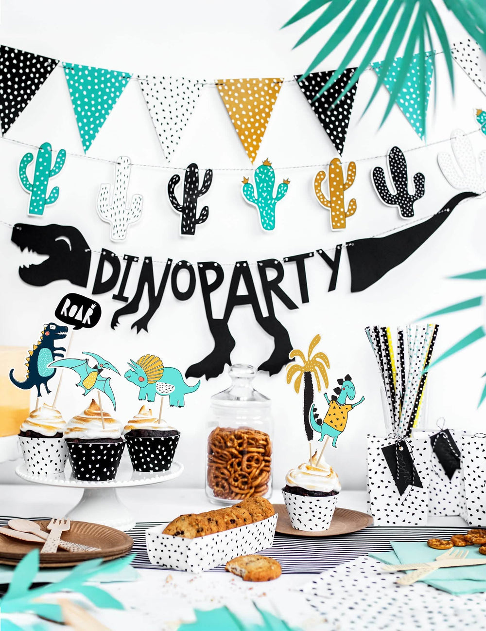 Encenação com buffet de festa com a grinalda de cartolina esqueleto dino party