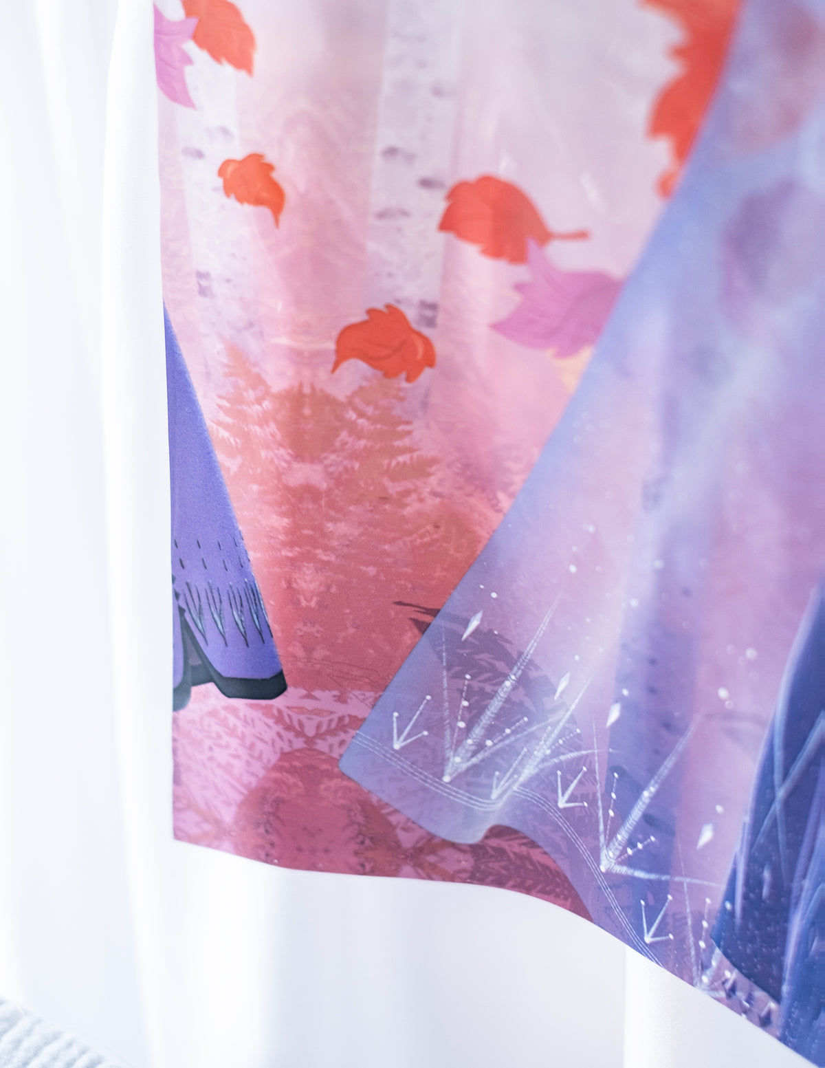 Gros plan sur les motifs de feuilles et de forêt de la nappe en plastique La Reine des Neiges 2