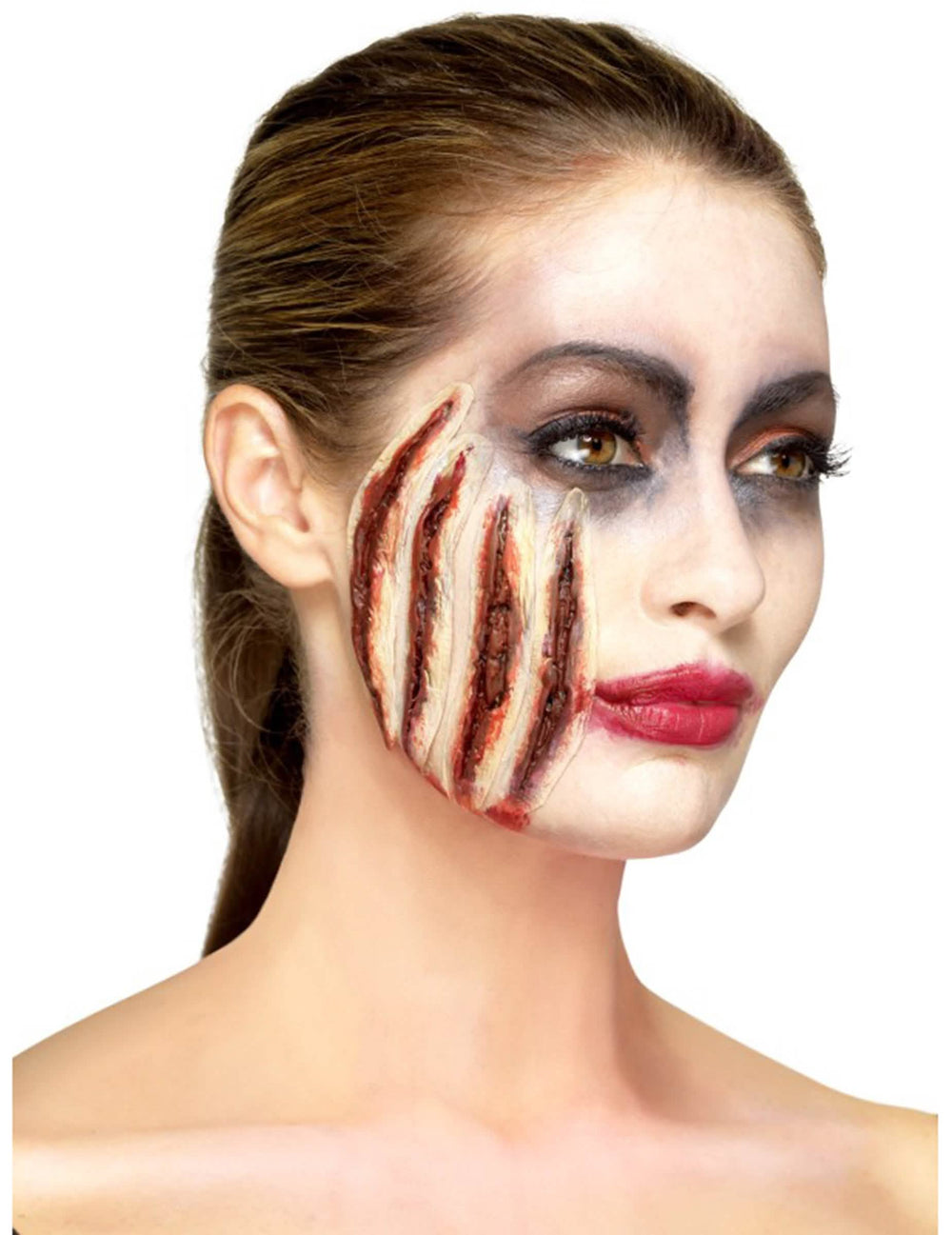 Vista de perfil da prótese de látex com cortes halloween
