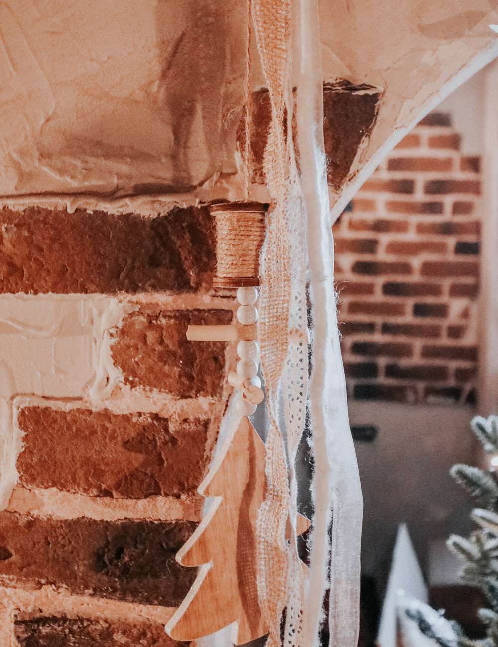 Gros plan sur les perles et la dentelle de la suspension en bois sapin style chalet